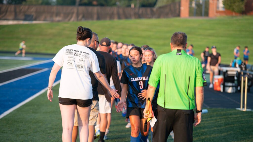 Lady Blue Devils cordially send off their opponents at the end of the game.