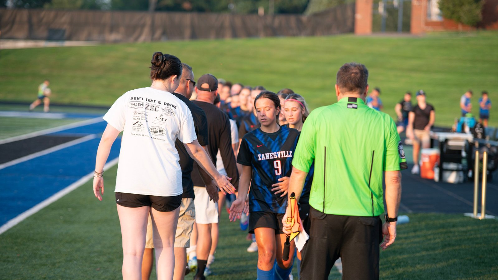 Lady Blue Devils cordially send off their opponents at the end of the game.
