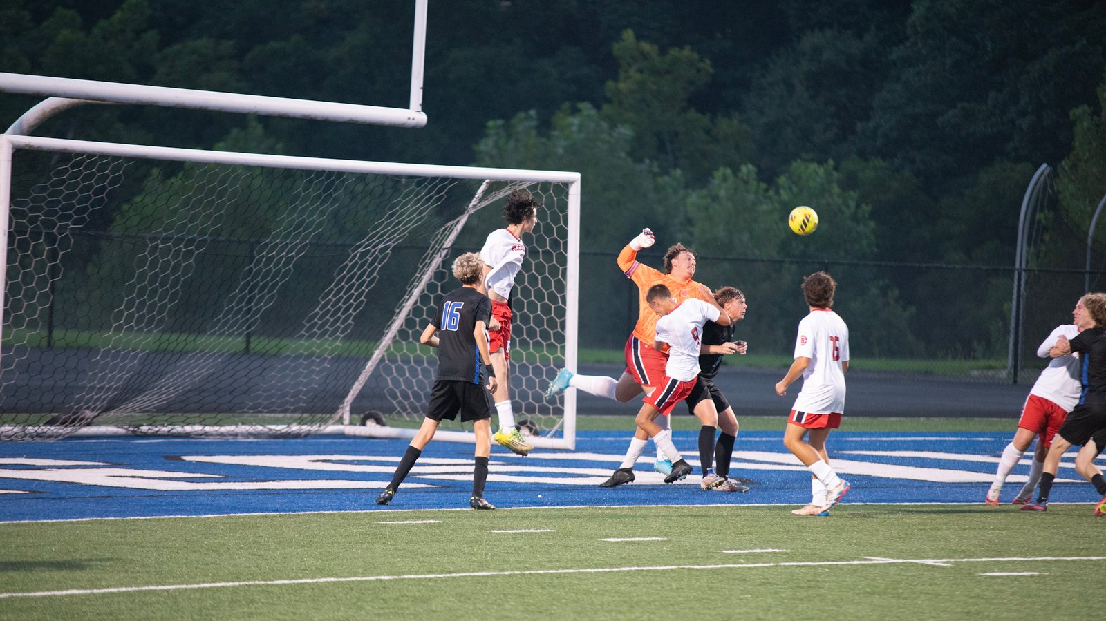 Bishop Rosecran's goalkeeper Dawson Larson fights an army of Blue Devils to defend a corner kick.