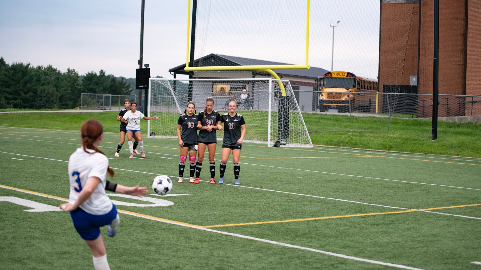 Layken Cochran, Anna Wolfe, and Maggie Martin defend for the Lil' Muskies against a Maysville foul kick.