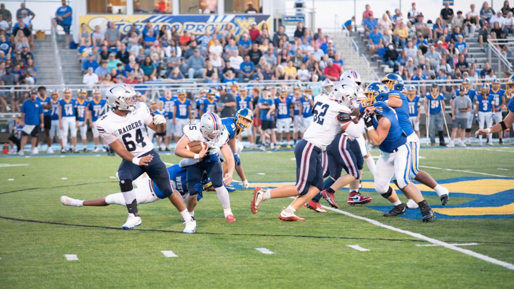 Morgan's quarterback Henry Davisson tries to gain positive yards against West Muskingum.