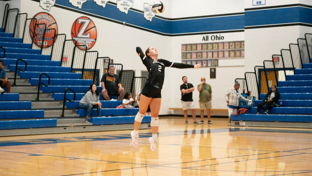 Zanesville's Cyaira Wallace serves the ball to Coshocton.