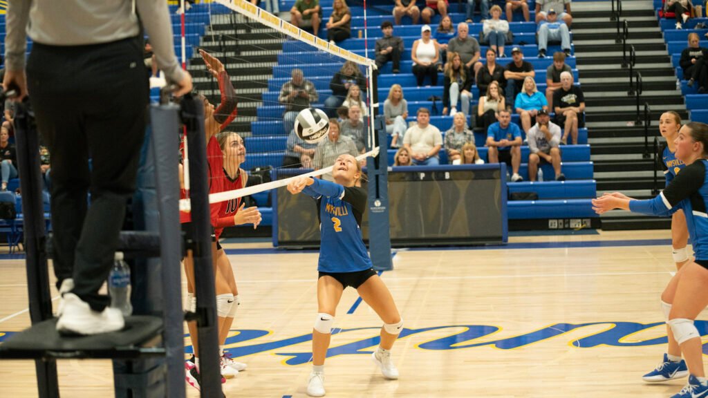Maysville's Riley Dooley hits the ball to send it back over to Coshocton.