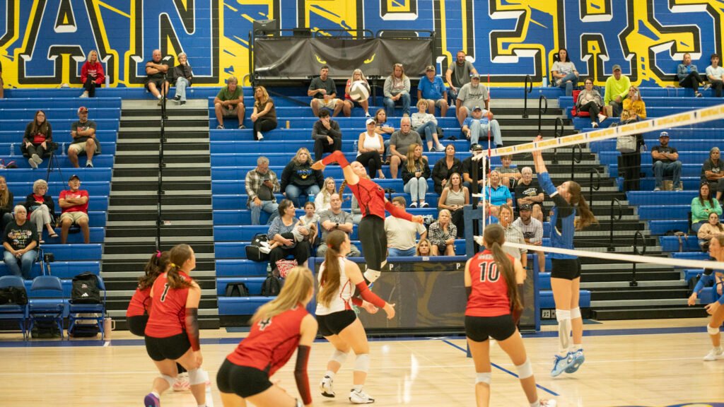 Coshocton's Mallorie Stamper jumps aloft for a kill against Maysville.